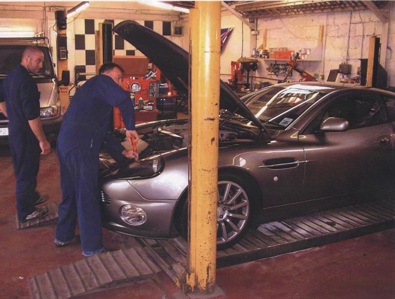 Technicians working on a car on the ramp in the Abbey Motorists Centre workshop